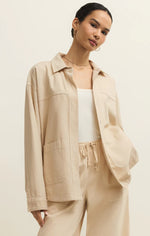 Load image into Gallery viewer, Woman wearing a beige jacket and pants on a plain background
