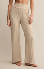 Load image into Gallery viewer, Beige ribbed pants worn by a person on a beige background

