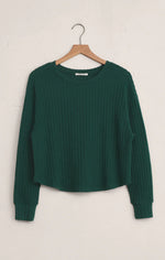 Load image into Gallery viewer, Green ribbed sweater on a wooden hanger against a white background
