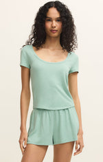 Load image into Gallery viewer, Woman wearing a light green tee with round neckline and shorts set. 
