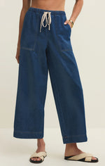 Load image into Gallery viewer, Person wearing blue wide-leg pants with a white background
