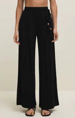 Load image into Gallery viewer, Black wide-leg pants with gold bead detail on a neutral background
