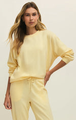 Load image into Gallery viewer, Woman wearing a yellow crewneck sweatshirt against a plain background
