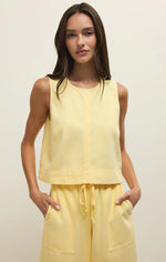 Load image into Gallery viewer, Woman wearing a yellow sleeveless top and pants against a plain background
