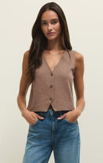 Load image into Gallery viewer, Woman wearing a brown button-up sleeveless vest top and blue jeans against a plain background
