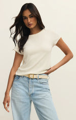 Load image into Gallery viewer, Woman wearing a white ribbed t-shirt and light blue jeans with a beige belt.
