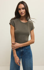Load image into Gallery viewer, Woman wearing an olive green ribbed  t-shirt and blue jeans against a plain background
