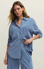 Load image into Gallery viewer, Woman wearing a blue knit denim shirt and pants on a plain background
