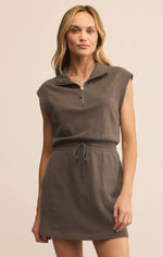 Load image into Gallery viewer, Woman wearing a brown sleeveless dress with a zipper on a beige background
