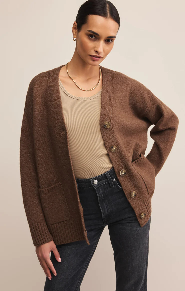 Oversized suede brown cardigan with v neckline, large button closure, front pockets, and rubbed detailing around cuff and hem. 