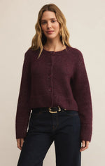 Load image into Gallery viewer, Woman wearing a maroon sweater and dark jeans on a beige background
