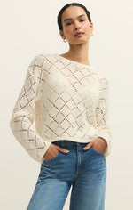 Load image into Gallery viewer, Woman wearing a white crochet sweater and blue jeans on a plain background
