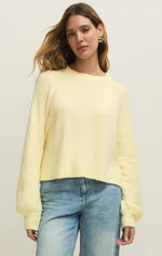 Load image into Gallery viewer, Woman wearing a light yellow sweater and blue jeans against a plain background
