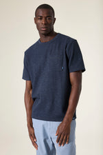 Load image into Gallery viewer, Man wearing a navy blue t-shirt with a chest pocket on a plain background
