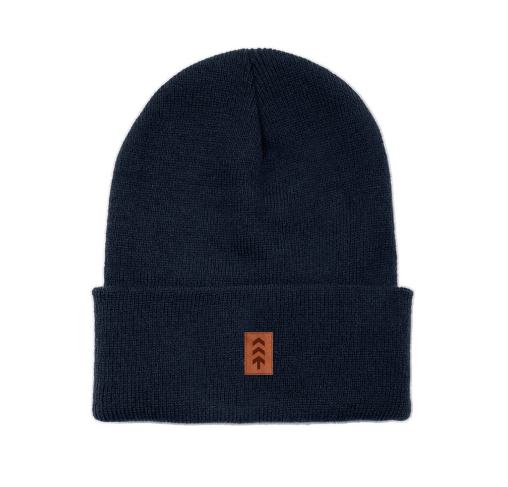 Navy beanie with a brown logo patch on a white background