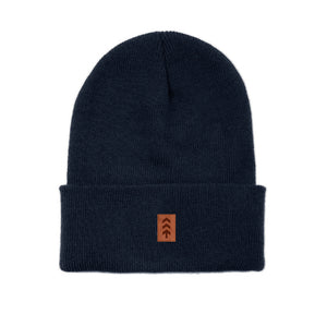 Navy beanie with a brown logo patch on a white background