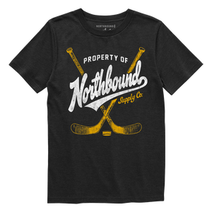 Black t-shirt with 'Property of Northbound Supply Co.' text and hockey stick graphics on a white background