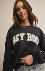 Load image into Gallery viewer, Person wearing a black sweatshirt with 'Hey Boo' text on a neutral background
