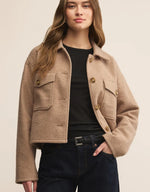 Load image into Gallery viewer, Woman wearing a beige textured cropped utility jacket. 
